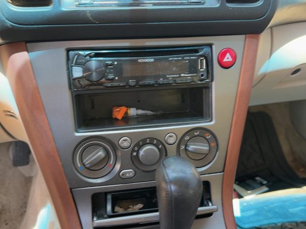 2005-2007 Subaru Legacy Outback Radio Trim Bezel Surround Taupe OEM 66040AG02A — photo 1