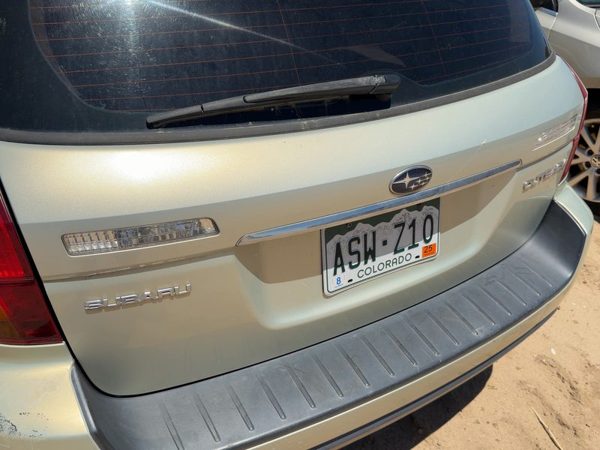 05-09 Legacy Outback License Plate Trim Surround Panel Tail Trunk Finish Gold 9J — photo 1